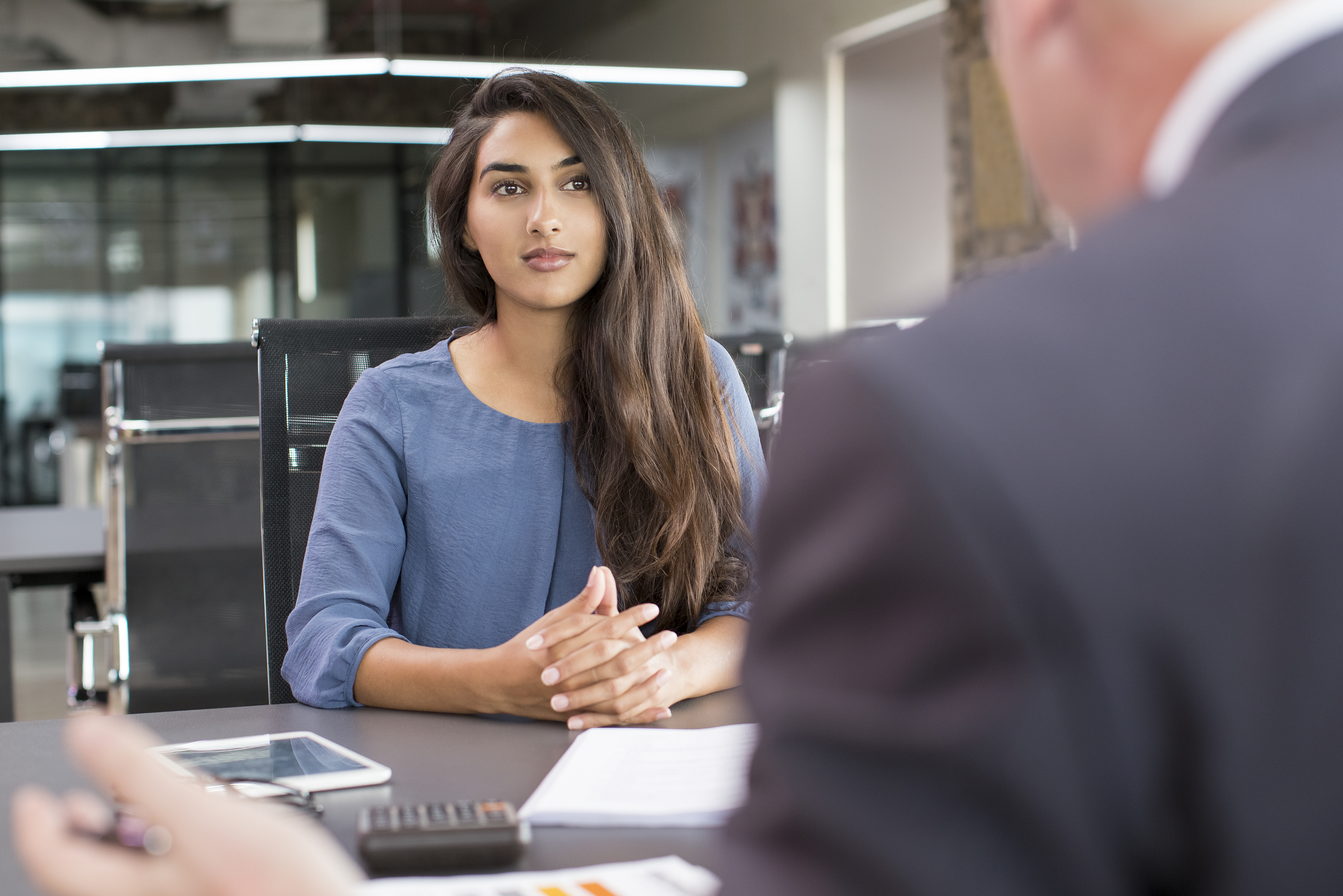 Focused Indian female customer meeting with financial advisor