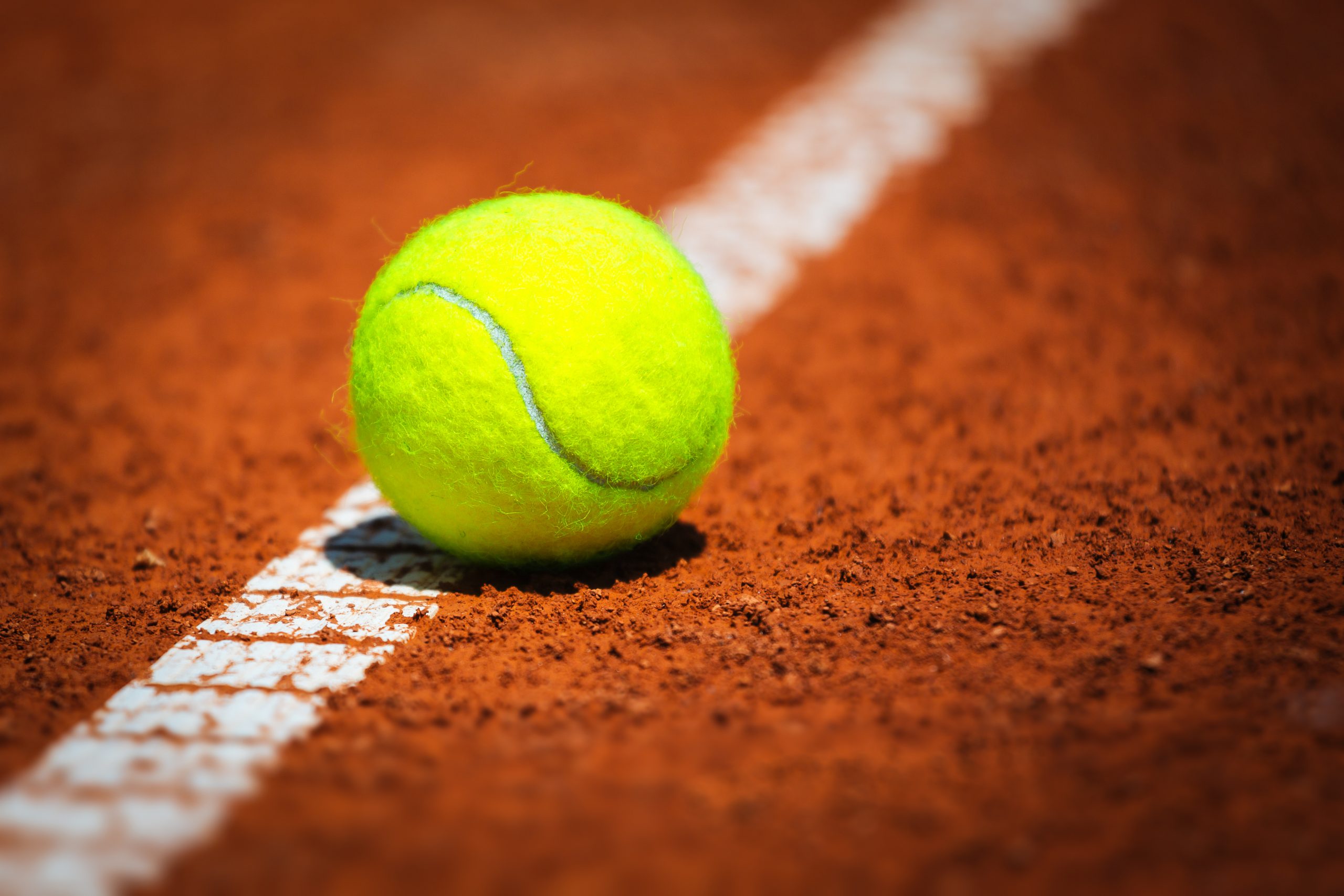 Tennis ball on clay court
